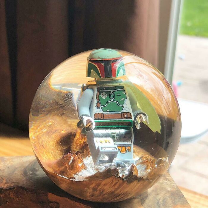 Lego figure encased in a clear spherical resin, showcasing a unique and creative DIY project idea.