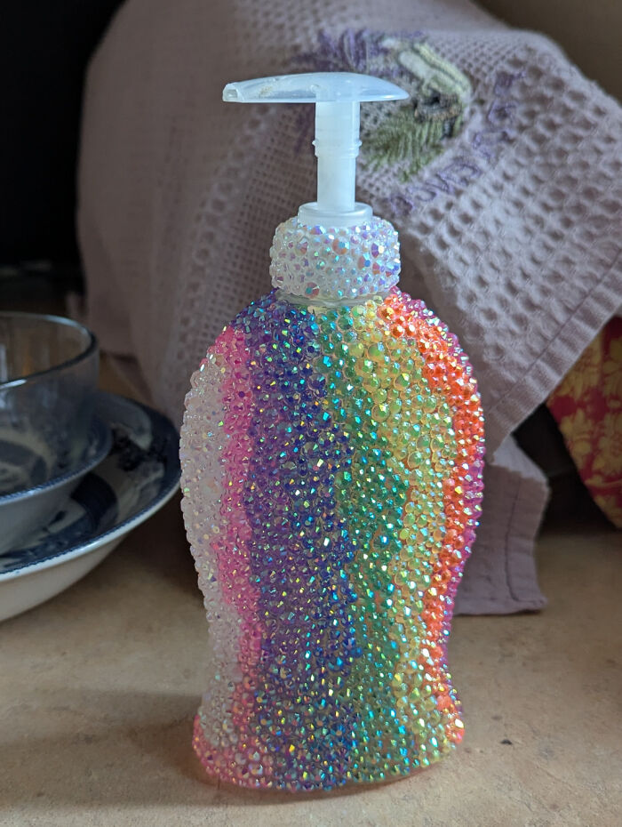 Decorated soap dispenser covered in rainbow-colored DIY beads showcasing creative DIY projects.