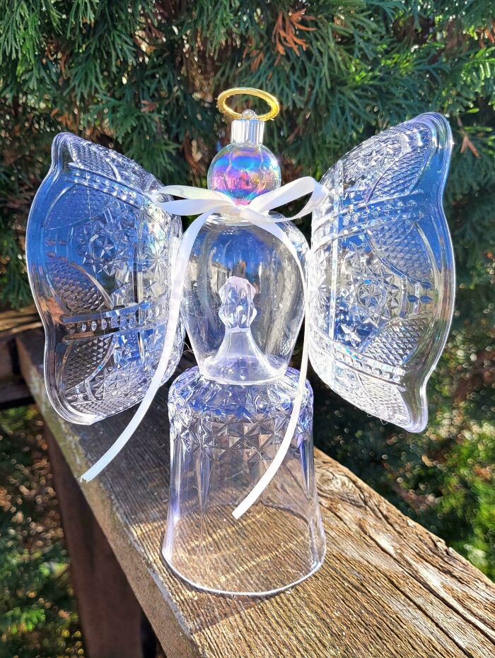 Clear glass angel figure made from repurposed glassware, showcasing a creative DIY project with intricate details outdoors.