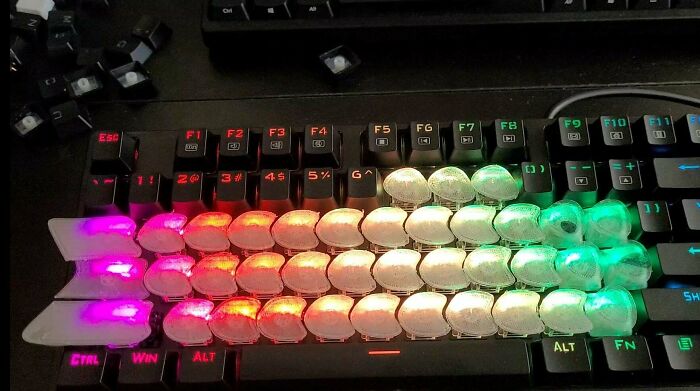 DIY project with colorful LED lights arranged on a custom-built keyboard modification showing unique handmade design.
