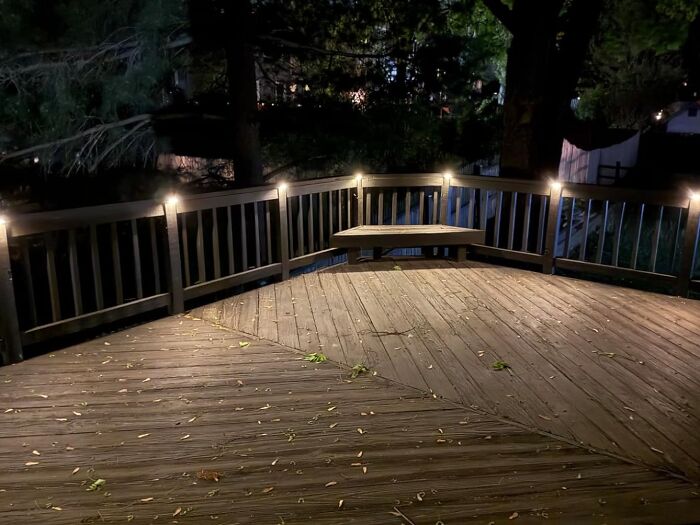 Outdoor wooden deck with built-in seating and ambient lighting, showcasing popular Amazon finds for home improvement.