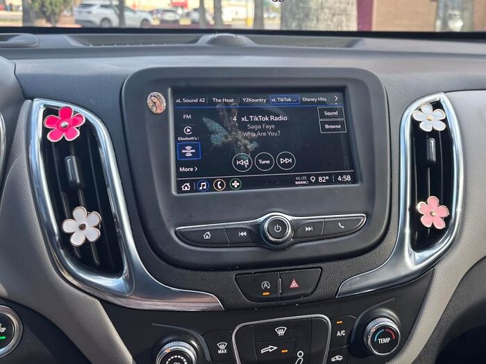 Car dashboard with air fresheners and digital display showcasing popular Amazon finds trending on wishlists today.