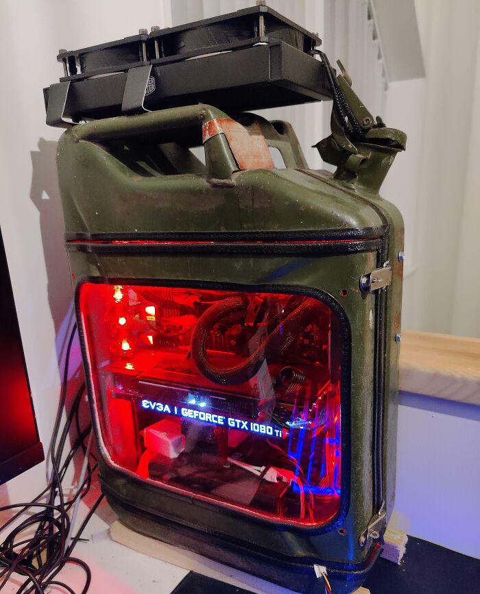 Custom DIY PC build inside a modified vintage metal container with visible EVGA GeForce GTX 1080 Ti graphics card.