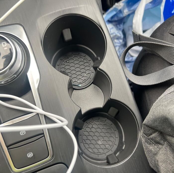 Car cup holder inserts from popular Amazon finds protecting the console with a textured grip design to hold drinks securely.