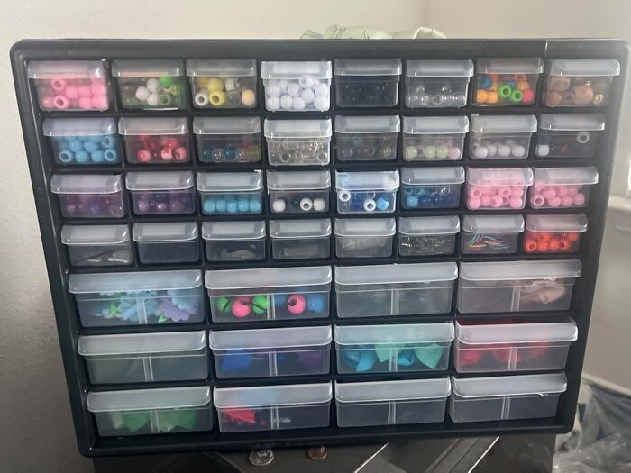 Small black storage organizer with multiple clear plastic drawers filled with colorful beads and craft supplies from Amazon finds.