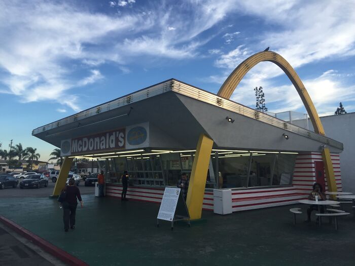 Vintage McDonald's building with classic golden arches showcasing how things used to look in past decades.