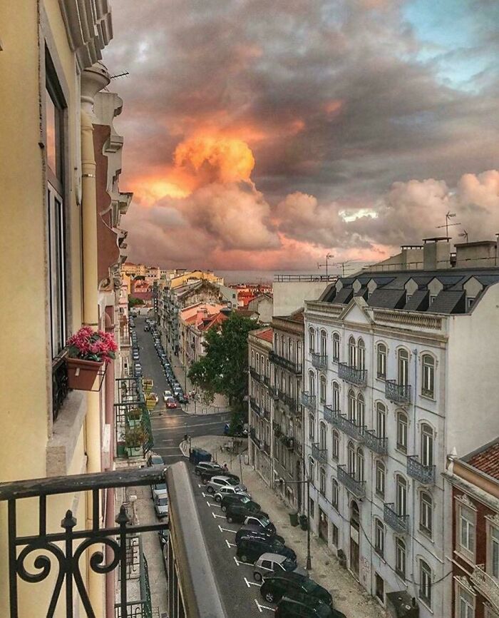 Sunset over city street with clouds that require a double take to realize what they really are in an urban setting.