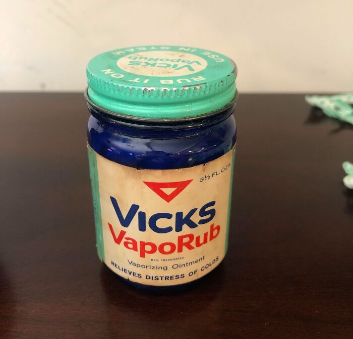 Vintage Vicks VapoRub blue glass jar with green lid, an old remedy that perfectly portrays how things used to look.