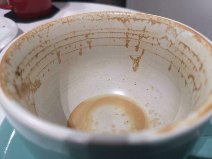 Close-up of a coffee cup with residue inside, an interesting thing that requires a double take to realize what it really is.