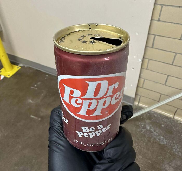 Vintage Dr Pepper can with unique slit top held in hand, perfectly portraying how things used to look decades ago.