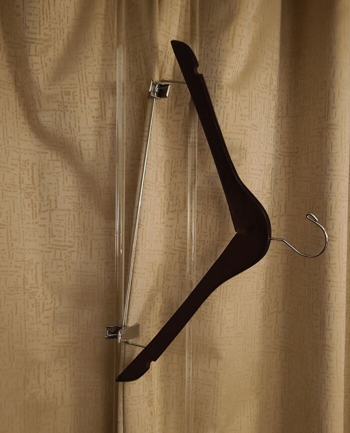 Creative solution using a clothes hanger and clips to fix or repurpose a common household item in clever ways.
