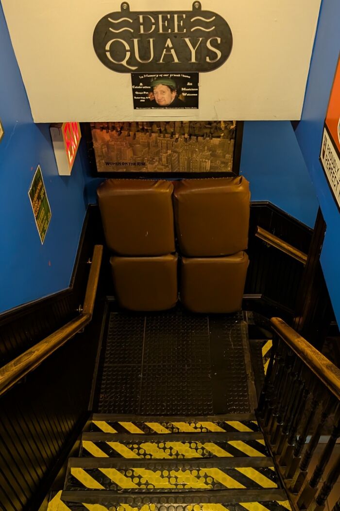 Staircase blocked with padded cushions as a clever way people solved safety issues in narrow stairs.
