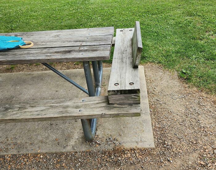 Wooden picnic table bench extended with an added backrest as a clever way people solved overlooked issues outdoors.