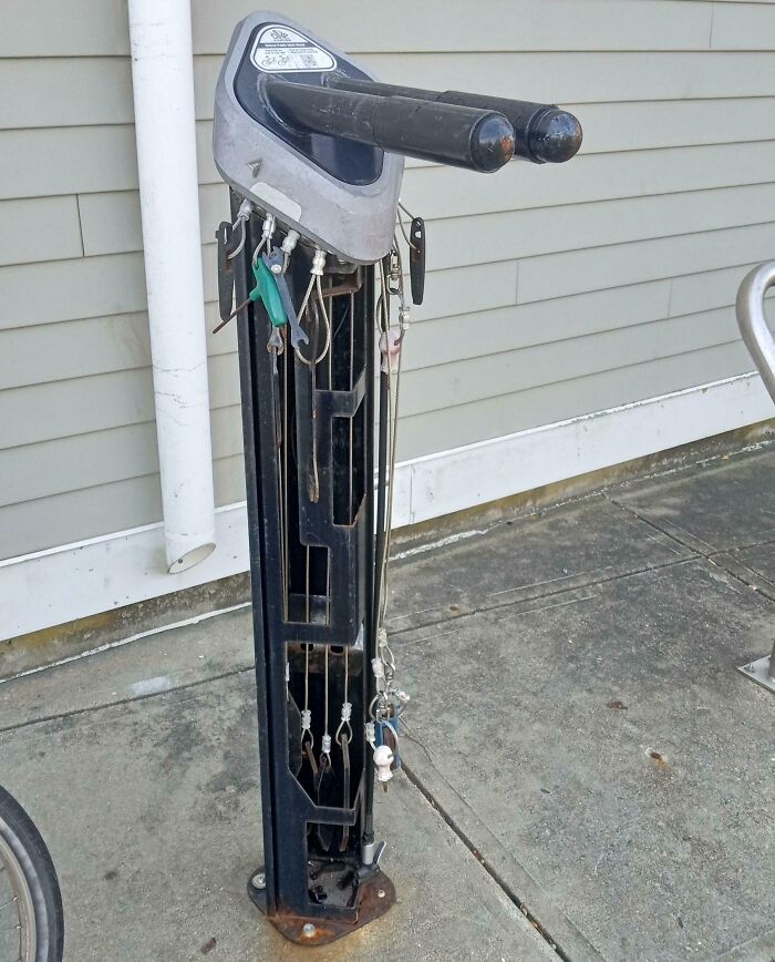 Bike repair station with tools neatly organized on hooks, demonstrating clever ways people solved overlooked issues outdoors.