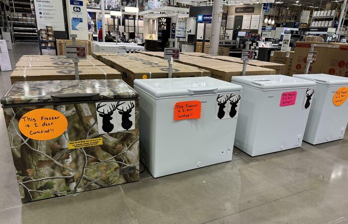 Freezers creatively labeled with deer stickers and colorful notes in a store, showcasing clever overlooked solutions.