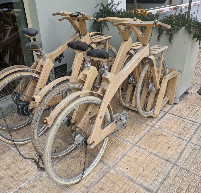 Wooden bicycles locked to a stand, showcasing incredibly clever ways people solved overlooked transportation issues.