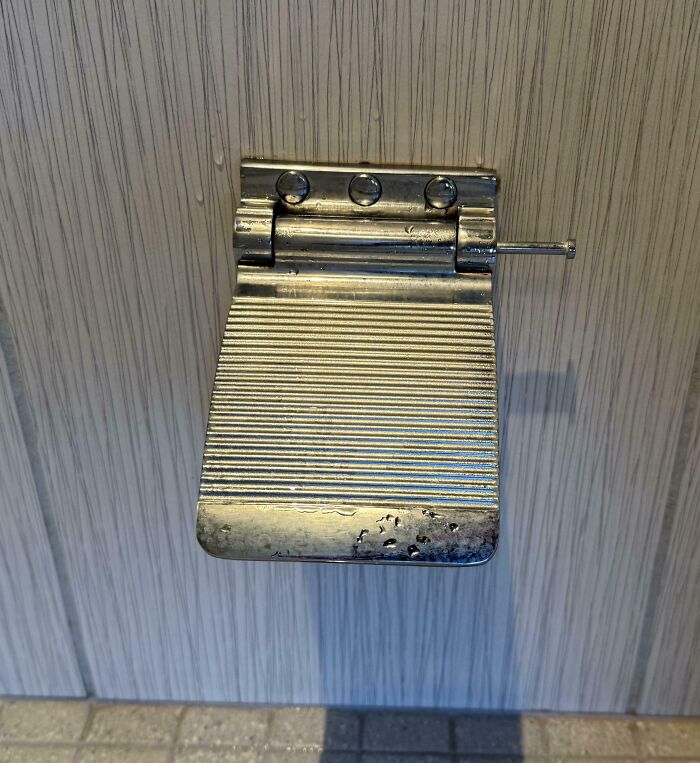 Metal door latch modified with a pin to solve an overlooked issue, showcasing a clever practical fix idea.