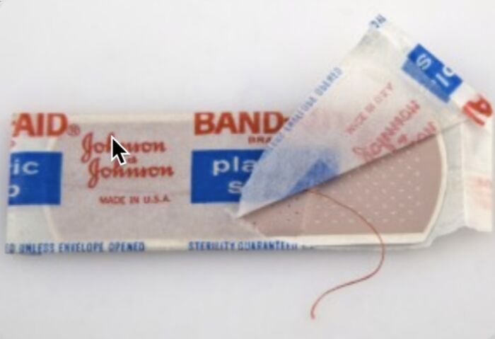 Vintage Johnson & Johnson adhesive bandage partially unwrapped, showcasing nostalgic packaging in a close-up image.
