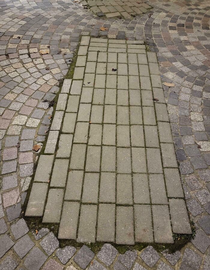 Mismatched pavement bricks creating a visually irritating patch, illustrating what mildly infuriated people shared about ruined moods.