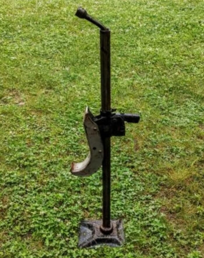 Vintage car jack standing on green grass, a nostalgic photo that might make you say heck I’m old.