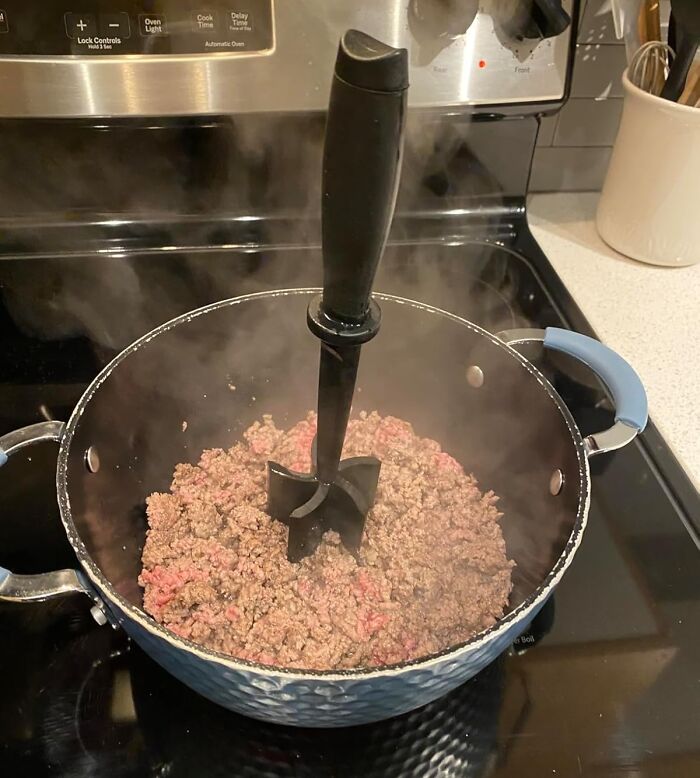 Pot of ground beef cooking on stove with a black meat chopper, one of the popular Amazon finds on wishlists now