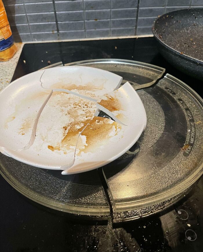Broken microwave plate and c*****d dirty dish inside, showcasing a mildly infuriated moment that ruined someone's mood.