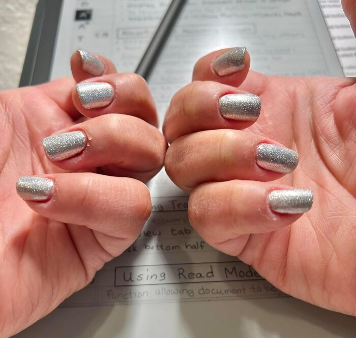 Hands with silver glitter nails displayed over a notebook, highlighting popular Amazon finds trending on wishlists now.