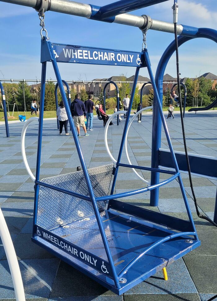 Wheelchair accessible swing at a playground designed as a clever solution for overlooked accessibility issues.