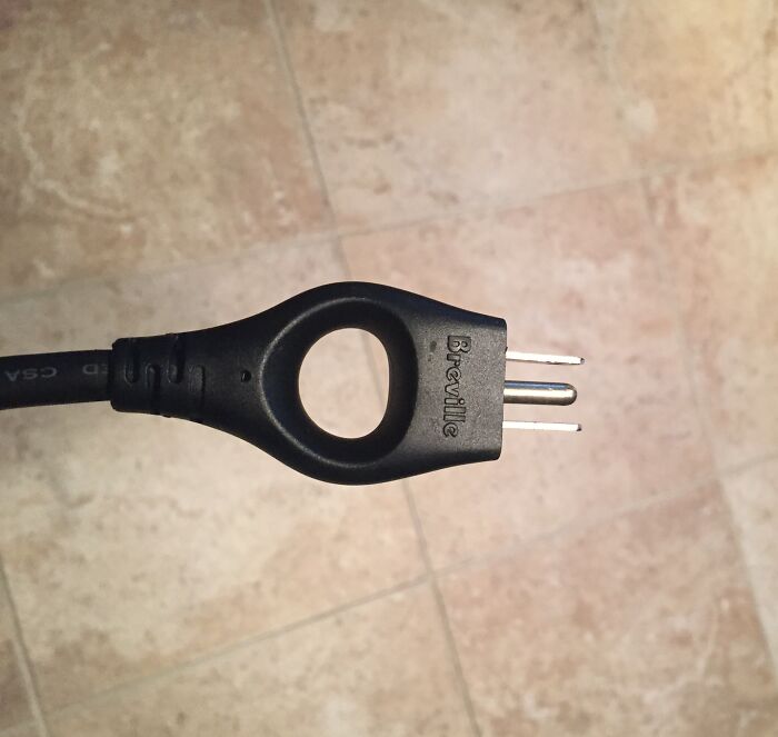 Black Breville power cord with a hollow circular grip, showcasing a clever overlooked design solution detail.