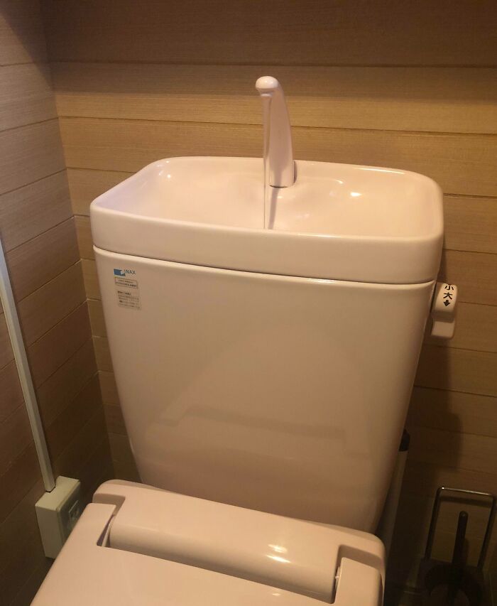 Toilet with a built-in sink on the tank, showing a clever way to save space and reuse water efficiently.