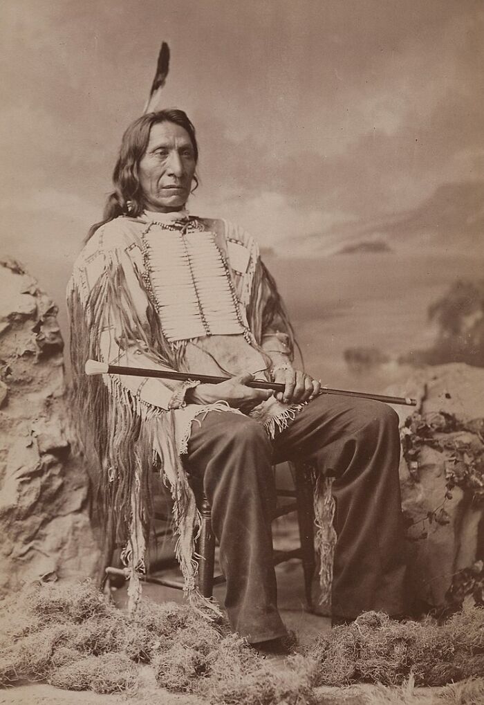 Native American man in traditional clothing and feather portrait capturing powerful Native American men heritage.