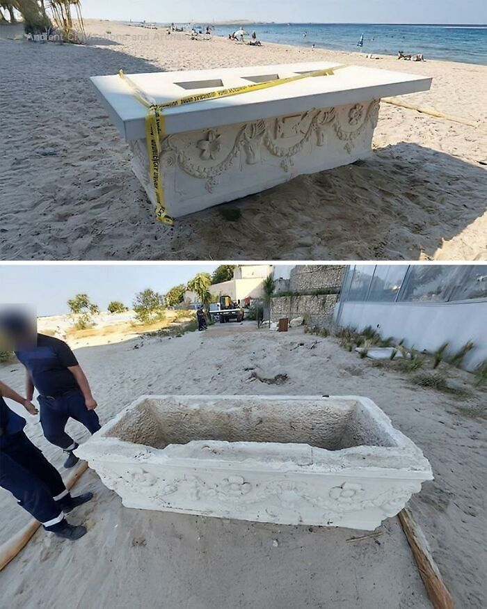 Ancient history artifact resembling a sarcophagus with intricate carvings found on a sandy beach area.