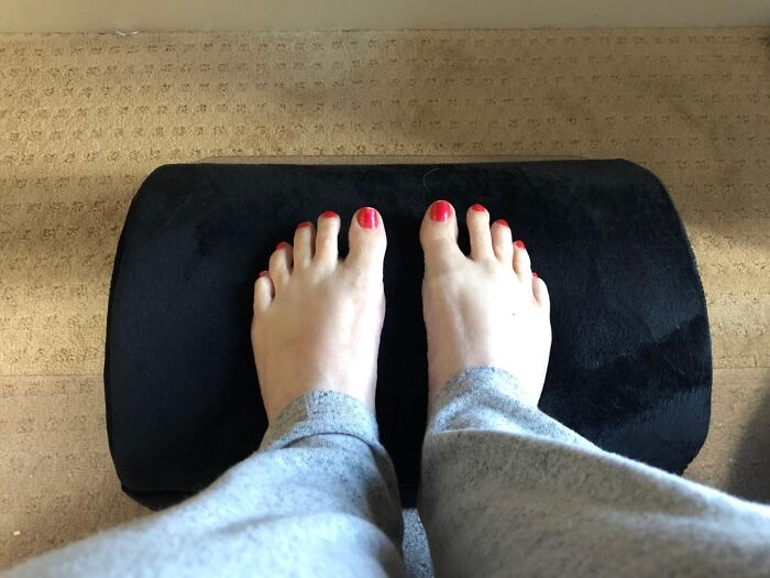 Feet with red nail polish resting on a black cushion, illustrating relaxation in making fancy lemonade from life lemons.