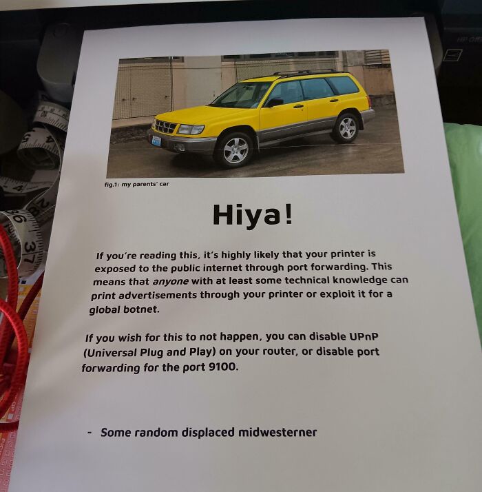 Printout showing a yellow car photo and a warning about chaotic good people exploiting printers via port forwarding.