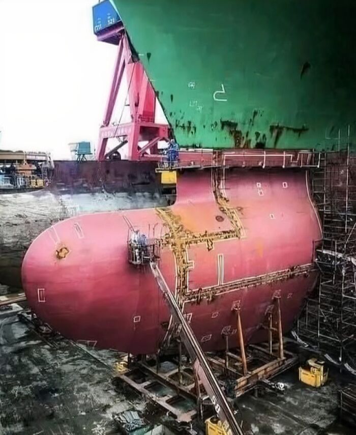 Shipyard workers repairing the large vessel hull section showing unusual, wonderful, and tragic things that actually happened.