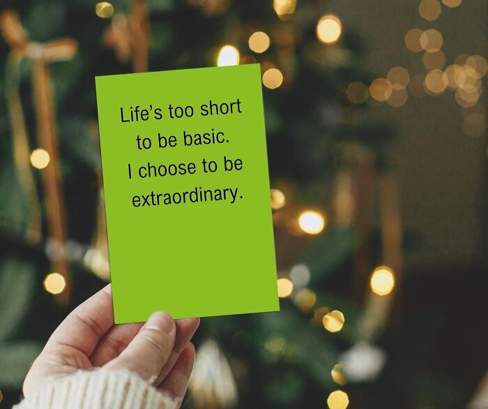 Hand holding a green card with motivational quote, a unique gift idea for beautifully unhinged friendship on Best Friends Day.