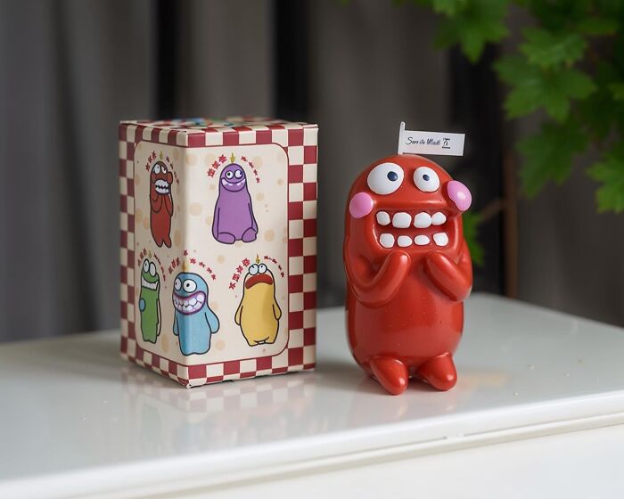 Colorful quirky figurine and gift box on table, representing gifts that sum up beautifully unhinged friendship for Best Friends Day.