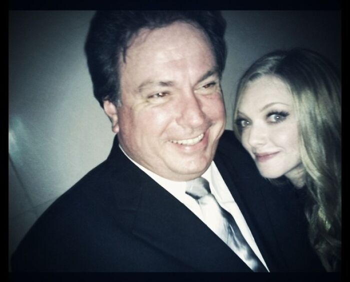 Man in suit smiling with woman with blonde hair posing closely, a vintage Instagram post celebrities shared long ago.