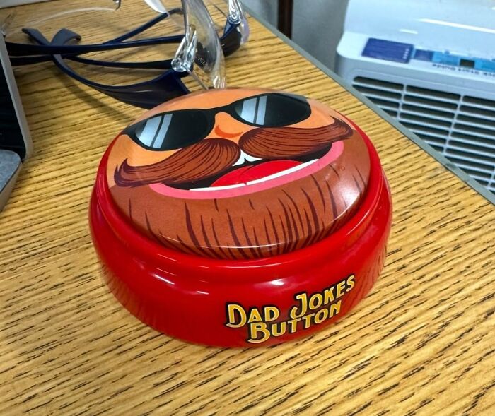 Dad jokes button gift on wooden table, a fun and unique Father's Day gift idea perfect for dads who love humor.