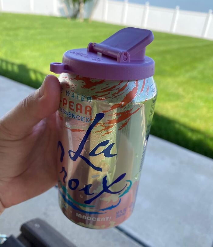 Hand holding a LaCroix can with a purple lid outdoors, showcasing a unique Father's Day gift idea.