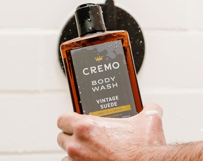 Cremo body wash held in wet hand, featured as a top Father's Day gifts idea for men looking for grooming products.