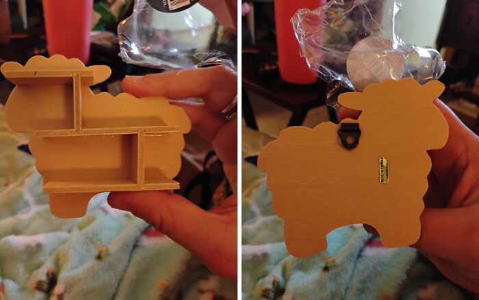 Wooden sheep-shaped shelf held in hand, one side showing compartments and the other a hanging hook, thrifted find.