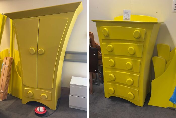 Two bright yellow, oddly shaped thrifted furniture pieces with curved drawers and doors in a storage room setting.