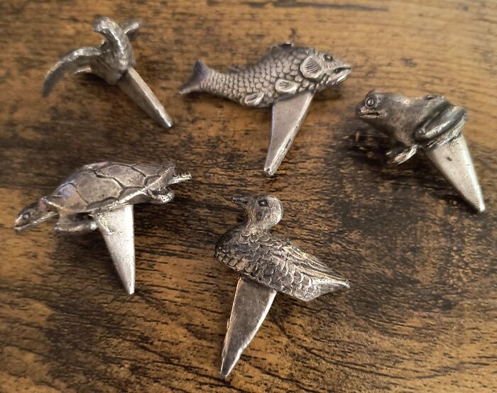 Collection of weird and wonderful thrifted finds shaped like animals, displayed on a wooden surface.