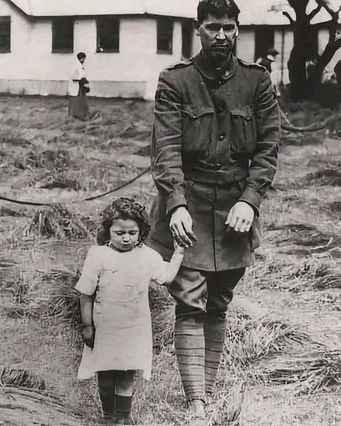 Black and white photo of a soldier holding a young girl’s hand, illustrating unusual and wonderful historical facts.