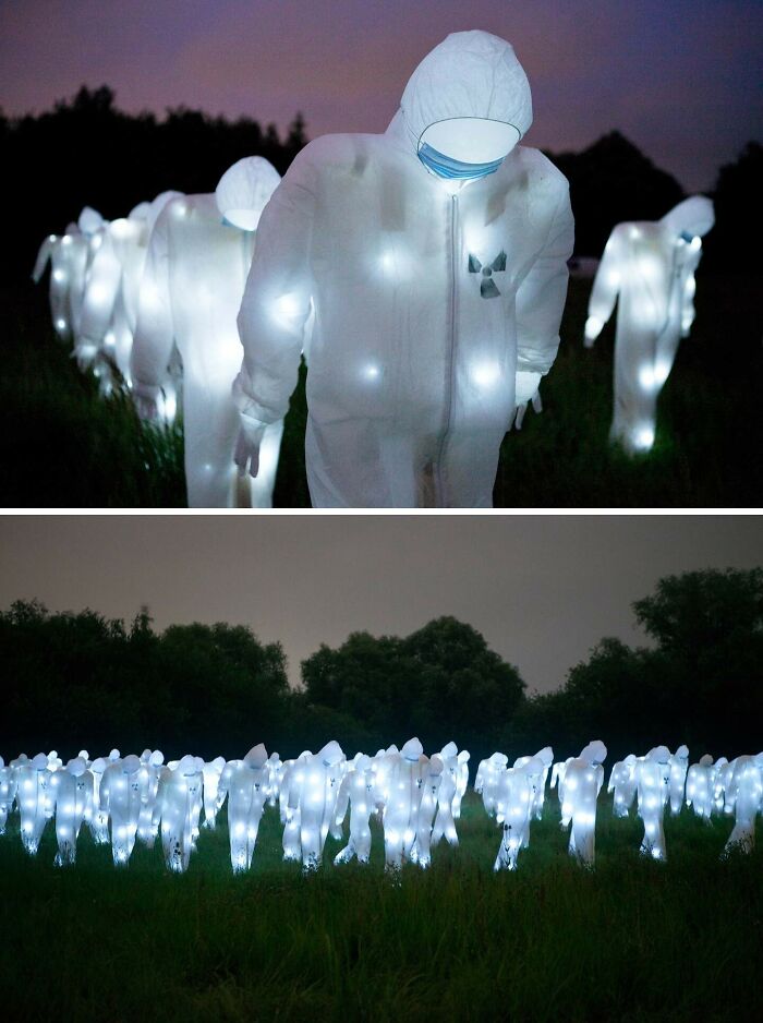 Glowing figures in protective suits gather outdoors at night, showcasing unusual and wonderful things that actually happened.