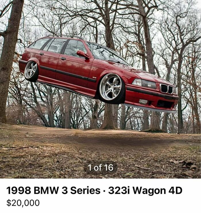 Red 1998 BMW 3 Series 323i wagon with custom rims captured mid-air in a forest setting from chaos cars for sale collection.