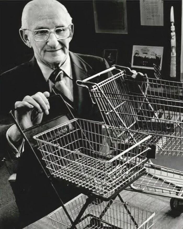 Elderly man demonstrating an unusual small shopping cart, highlighting interesting facts about unusual and wonderful inventions.