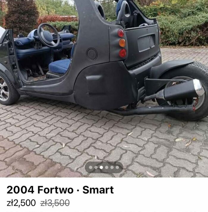 Black 2004 Fortwo Smart car in unusual condition, part of chaotic cars for sale collection on brick driveway.
