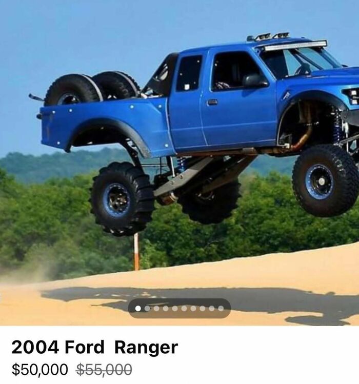 Blue 2004 Ford Ranger off-road truck jumping in sand, one of the chaotic cars spotted for sale in the collection.